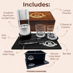 Pressice Barware Ice Ball Press Kit with anodized aluminum ice ball press, glasses, coasters, tongs, and silicone cube mold on a bar mat.